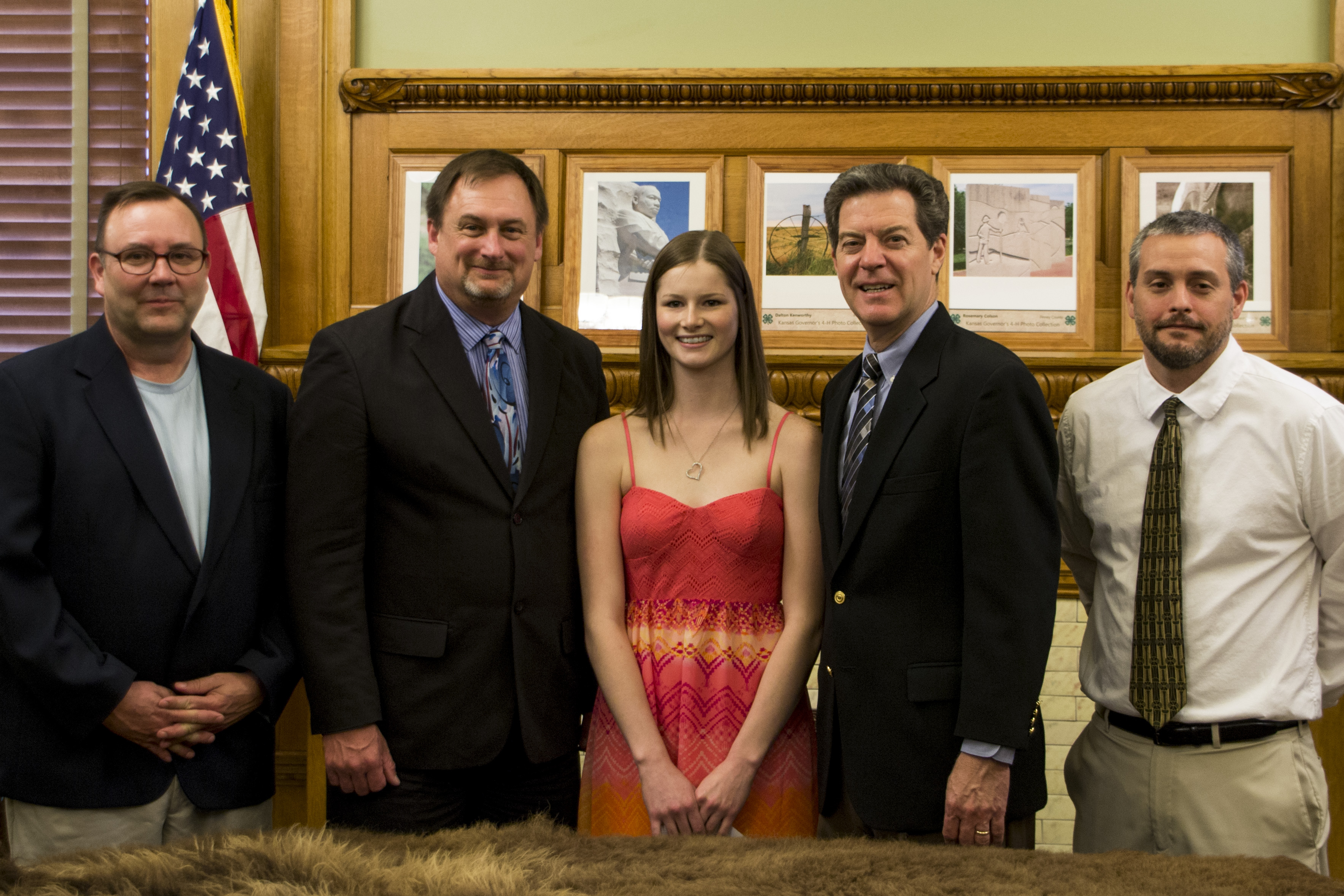 Governor Brownback posing for a photo with JAG participant and administrators.